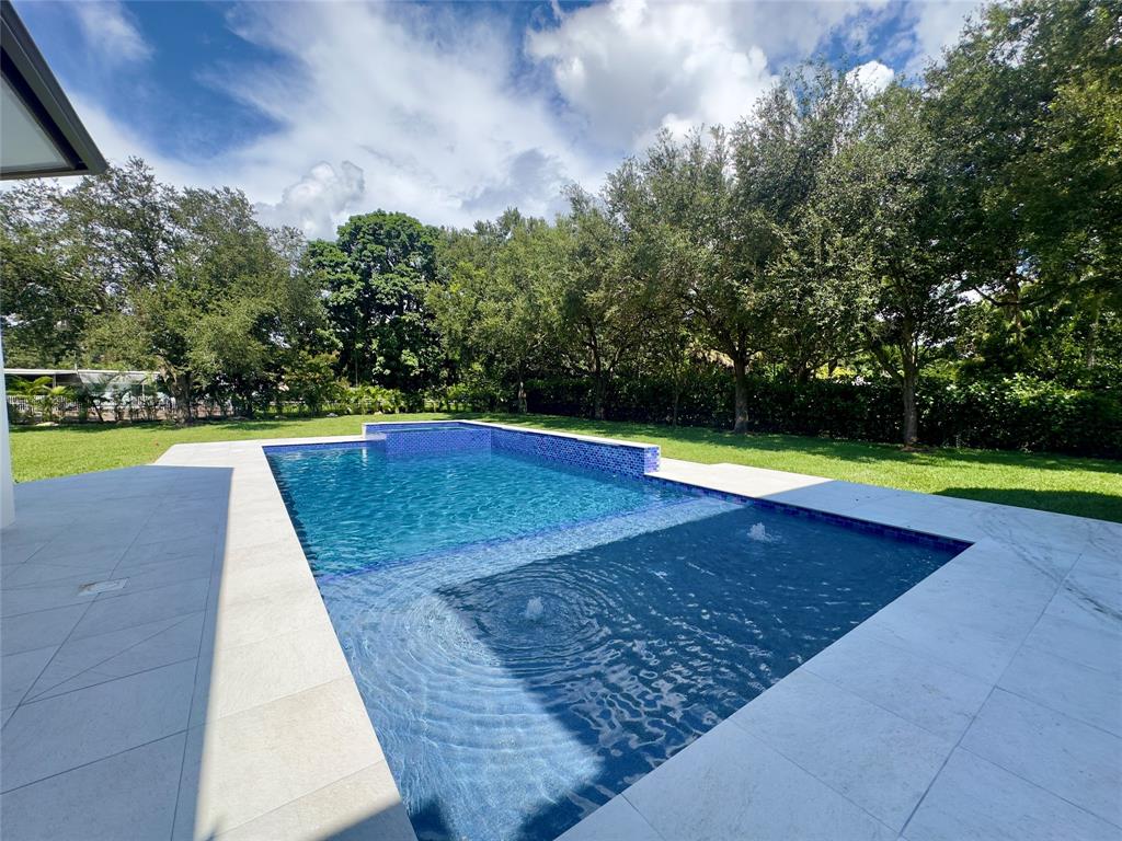 11951 Southwest 3rd Street Plantation, FL 33325 - Photo 19 of 59 a view of a swimming pool with an outdoor space and sitting space