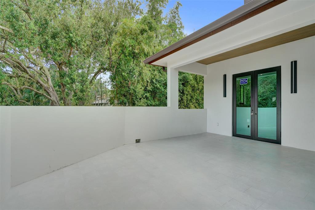 11951 Southwest 3rd Street Plantation, FL 33325 - Photo 48 of 59 view of a house with porch and garden