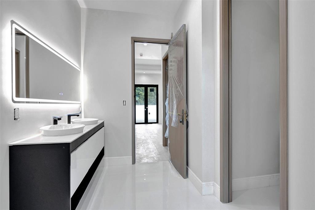 11951 Southwest 3rd Street Plantation, FL 33325 - Photo 53 of 59 a en suite bathroom with a sink and mirror