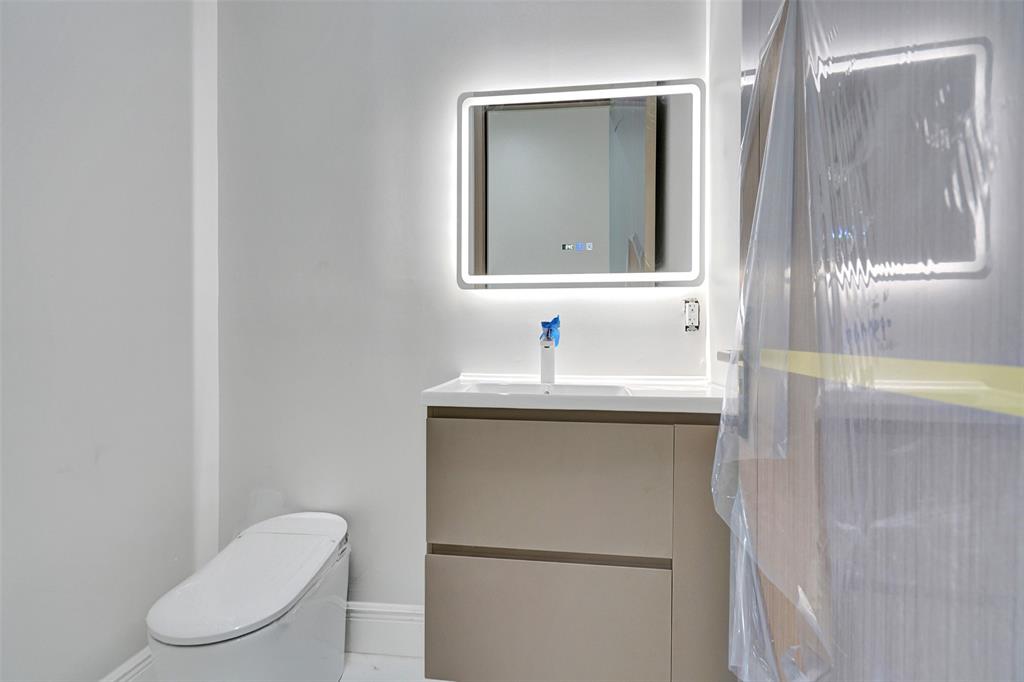 11951 Southwest 3rd Street Plantation, FL 33325 - Photo 58 of 59 a bathroom with a toilet sink and mirror