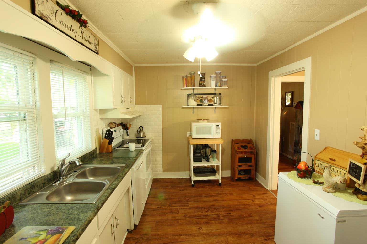 225 Franklin Road Lebanon, TN 37087 - Photo 13 of 21 a view of a kitchen with a sink and dishwasher with a fireplace