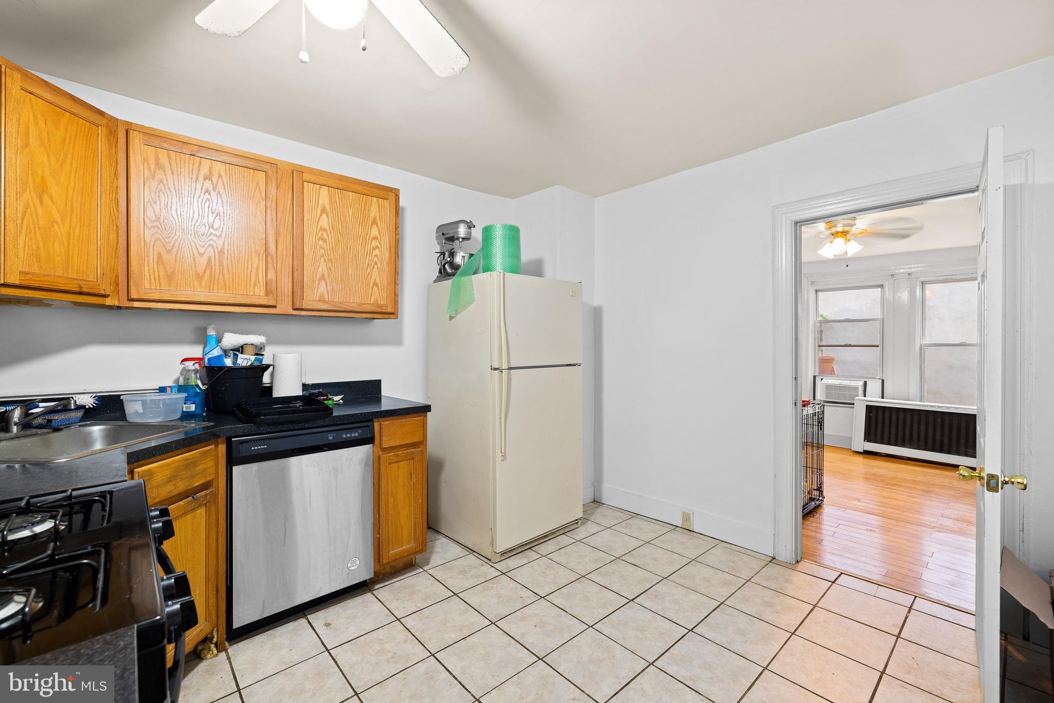 339 Christian Street, Unit 1 Philadelphia, PA 19147 - Photo 2 of 10 a kitchen with granite countertop a refrigerator a stove top oven and a sink