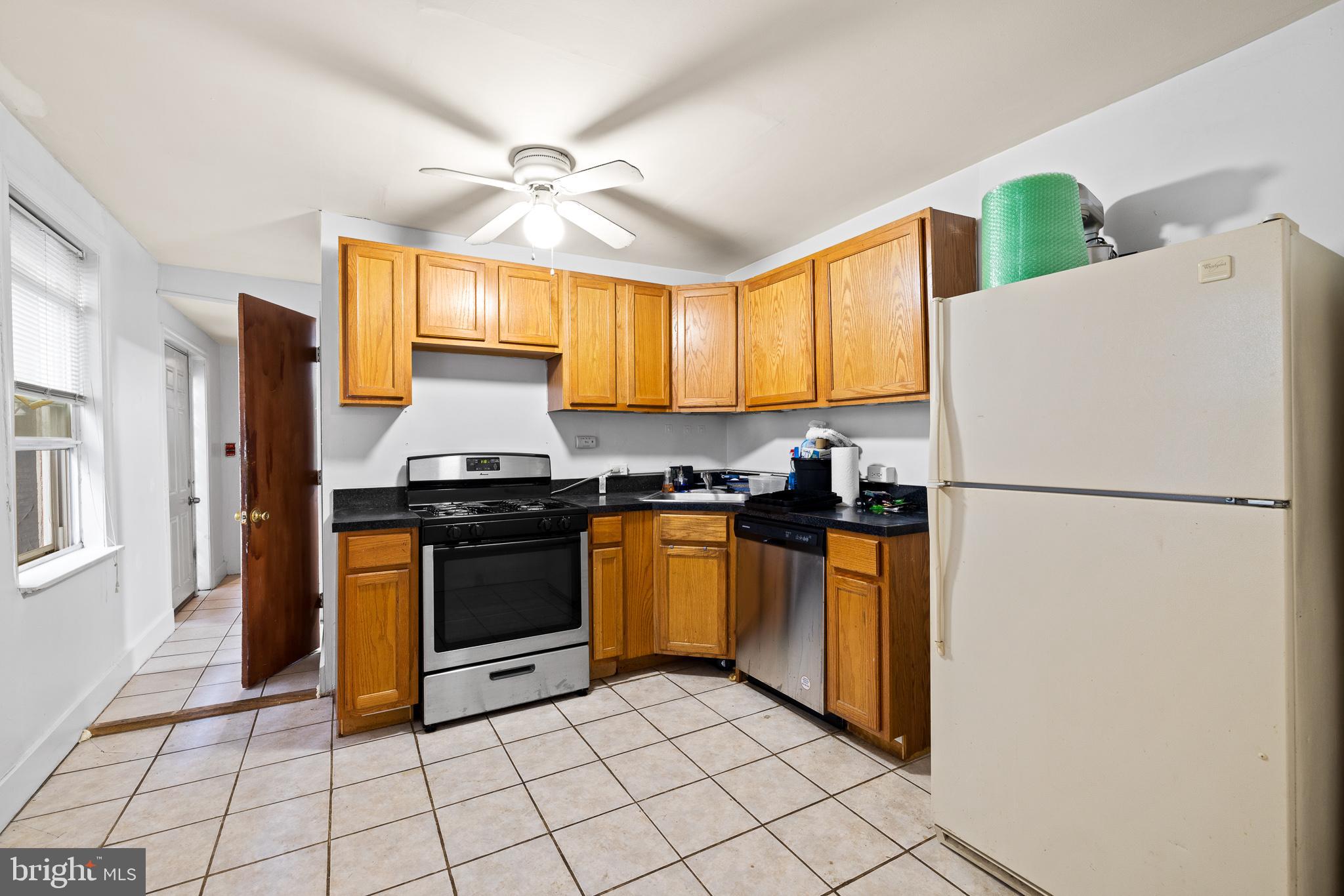 339 Christian Street, Unit 1 Philadelphia, PA 19147 - Photo 3 of 10 a kitchen with a refrigerator a stove top oven and cabinets
