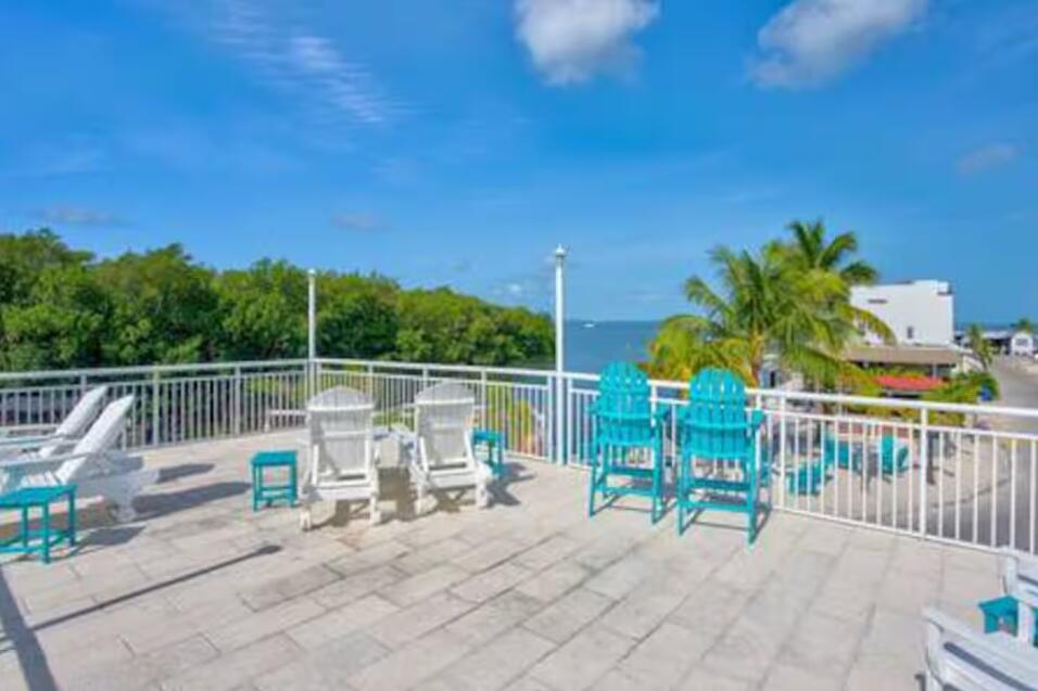 325 Calusa Street, Unit 231 Key Largo, FL 33037 - Photo 32 of 36 a view of a chair and tables on the patio