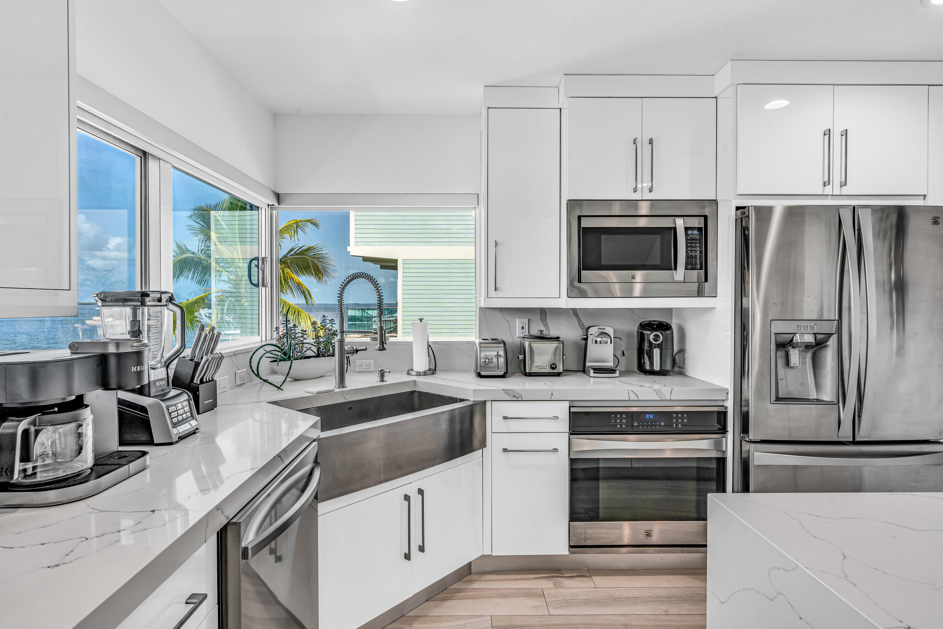 325 Calusa Street, Unit 231 Key Largo, FL 33037 - Photo 5 of 36 a kitchen with stainless steel appliances a sink a stove and a refrigerator