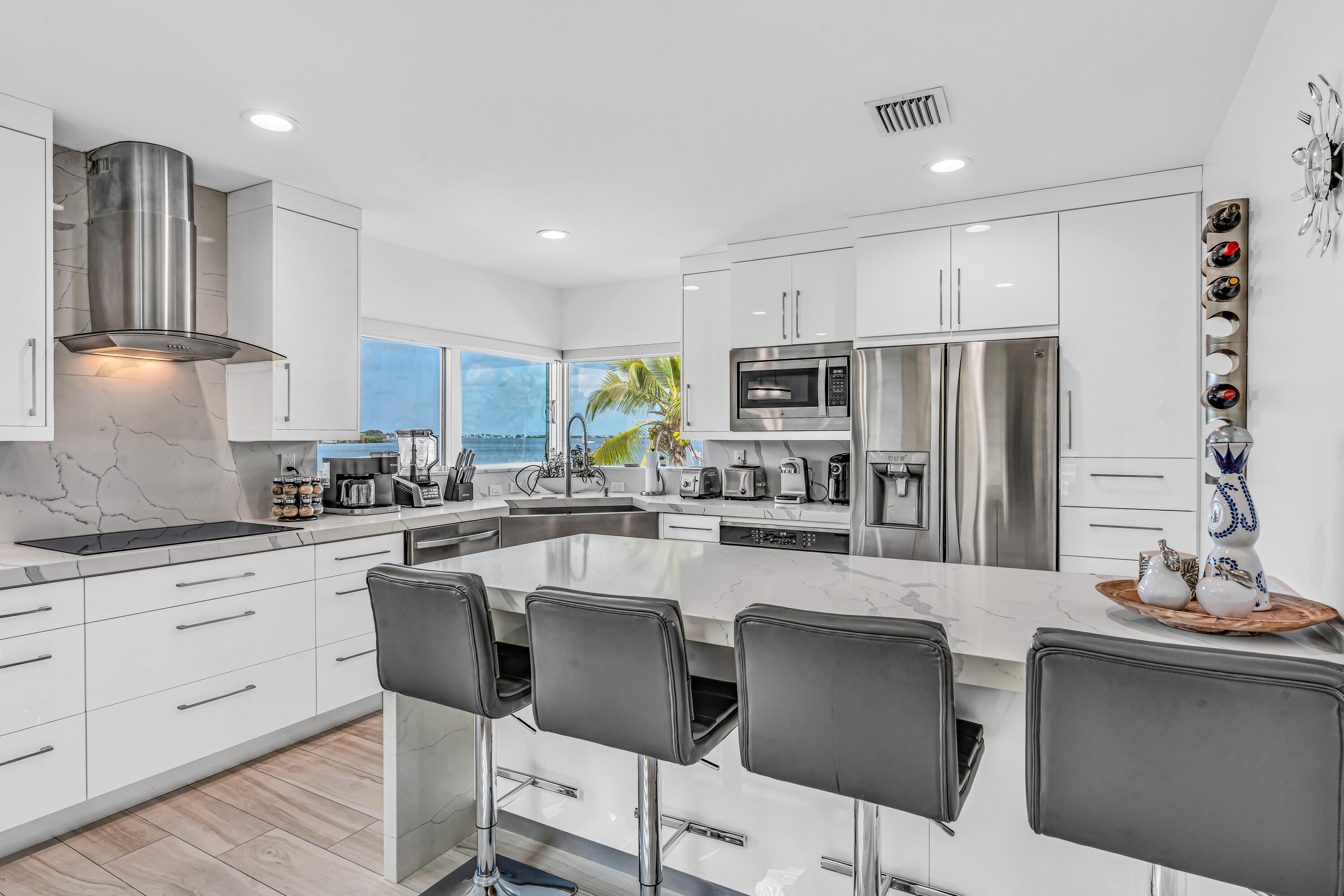 325 Calusa Street, Unit 231 Key Largo, FL 33037 - Photo 6 of 36 a kitchen with stainless steel appliances granite countertop a sink a stove a refrigerator cabinets and chairs
