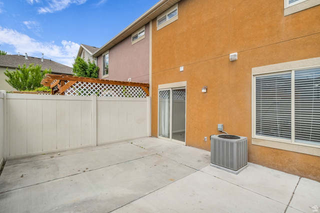 656 South 910 West, Unit 25 Pleasant Grove, UT 84062 - Photo 24 of 25 Relaxing back patio with durable concrete surfaces and enclosed privacy fencing, offering the perfect space for outdoor dining, entertaining, or quiet evenings at home.