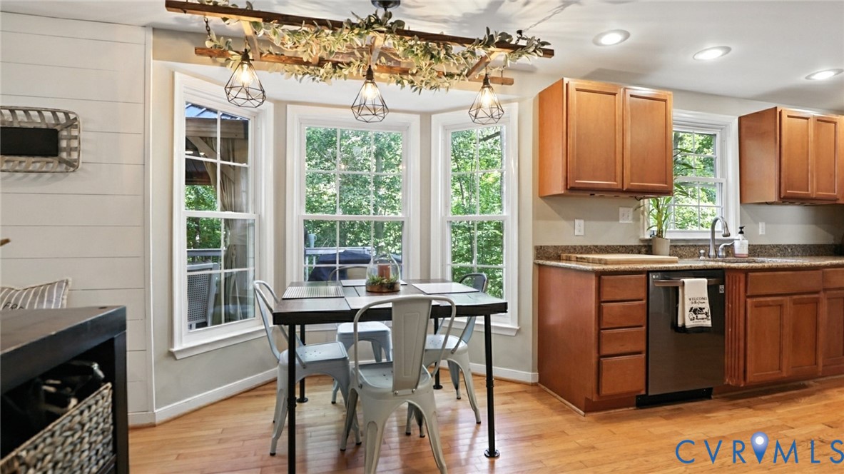 9743 Snowhill Road Richmond, VA 23235 - Photo 14 of 48 Kitchen featuring dark stone counters, light wood-