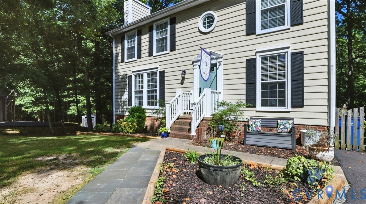 9743 Snowhill Road Richmond, VA 23235 - Photo 2 of 48 Property entrance with a chimney and a lawn
