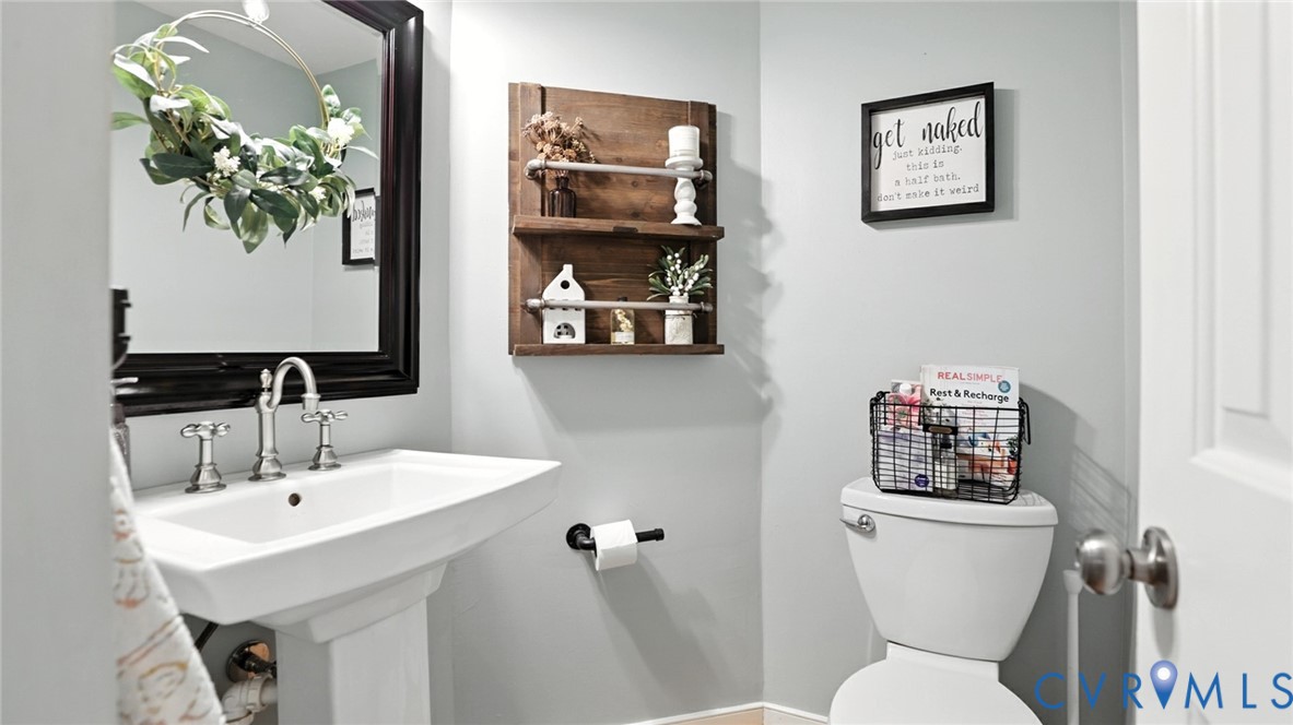 9743 Snowhill Road Richmond, VA 23235 - Photo 21 of 48 Half bathroom with toilet and baseboards