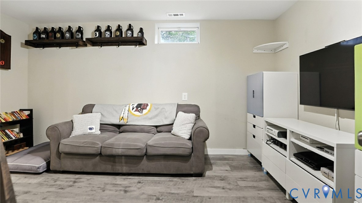 9743 Snowhill Road Richmond, VA 23235 - Photo 27 of 48 Living area with light wood finished floors and ba