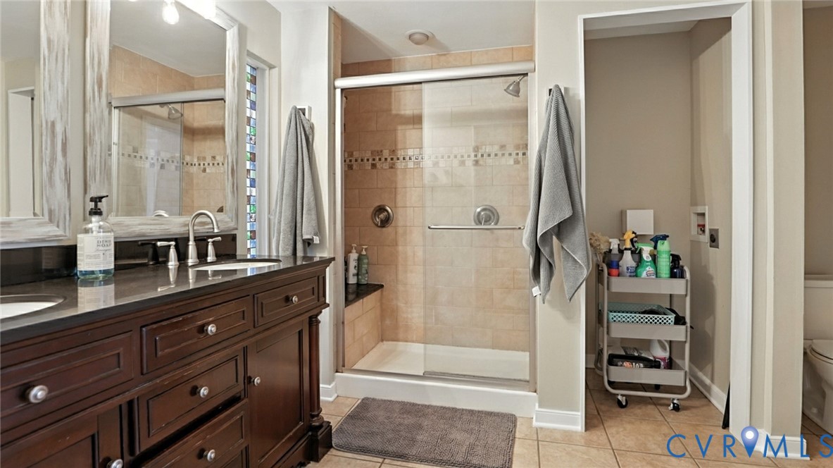 9743 Snowhill Road Richmond, VA 23235 - Photo 35 of 48 Full bathroom with double vanity, light tile patte