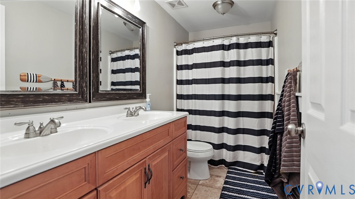 9743 Snowhill Road Richmond, VA 23235 - Photo 37 of 48 Full bath with double vanity, light tile patterned