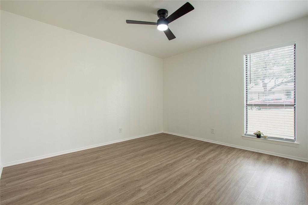 1205 Augusta Road Benbrook, TX 76126 - Photo 15 of 21 Spacious room featuring wood-finish flooring, a contemporary ceiling fan with integrated lighting, a large window with horizontal blinds, and white baseboards