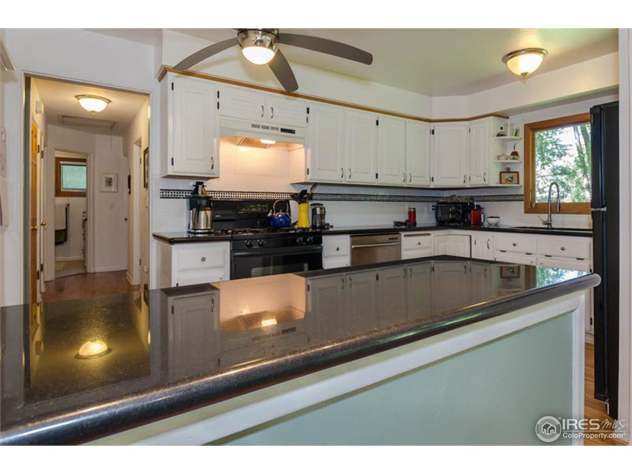 724 Gapter Road Boulder, CO 80303 - Photo 6 of 20 a kitchen with stainless steel appliances granite countertop a sink and a stove