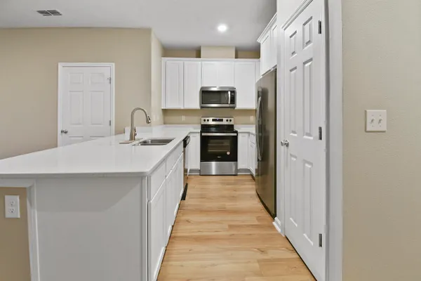a kitchen with stainless steel appliances a refrigerator stove and sink