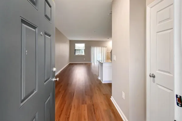 a view of hallway with wooden floor