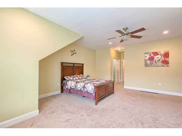 36 Indian Ridge Terrace, Unit 36 Westford, MA 01886 - Photo 11 of 23 a spacious bedroom with a bed and a painting on the wall