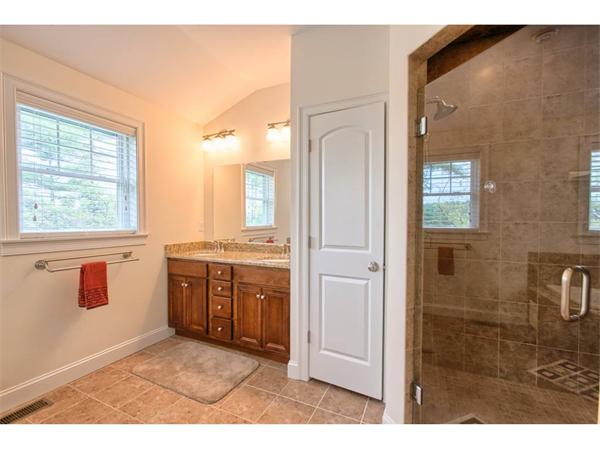 36 Indian Ridge Terrace, Unit 36 Westford, MA 01886 - Photo 12 of 23 a bathroom with a granite countertop sink a mirror and a bathtub