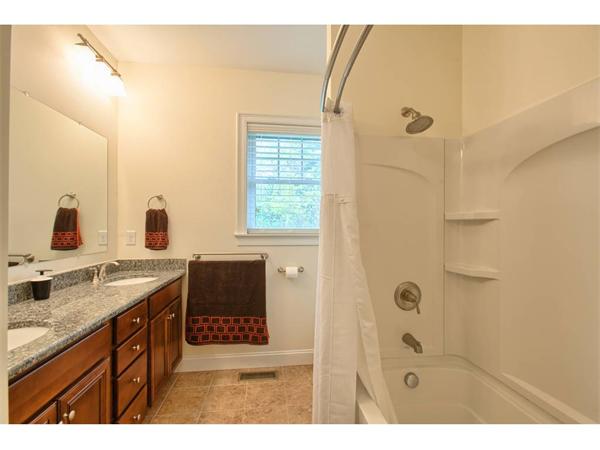 36 Indian Ridge Terrace, Unit 36 Westford, MA 01886 - Photo 13 of 23 a bathroom with a granite countertop sink a mirror and shower