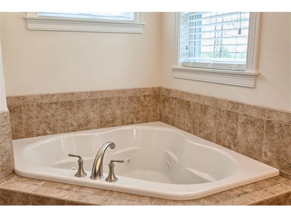 36 Indian Ridge Terrace, Unit 36 Westford, MA 01886 - Photo 15 of 23 a bath tub sitting in a bathroom next to a window