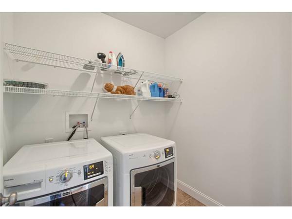36 Indian Ridge Terrace, Unit 36 Westford, MA 01886 - Photo 18 of 23 a utility room with dryer washer and empty racks