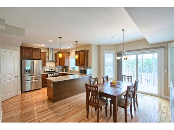 36 Indian Ridge Terrace, Unit 36 Westford, MA 01886 - Photo 4 of 23 a large kitchen with a table and chairs