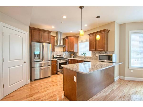 36 Indian Ridge Terrace, Unit 36 Westford, MA 01886 - Photo 7 of 23 a kitchen with stainless steel appliances granite countertop a refrigerator a sink dishwasher a oven with white cabinets