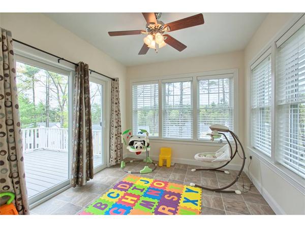 36 Indian Ridge Terrace, Unit 36 Westford, MA 01886 - Photo 9 of 23 a living room filled with furniture and floor to ceiling windows