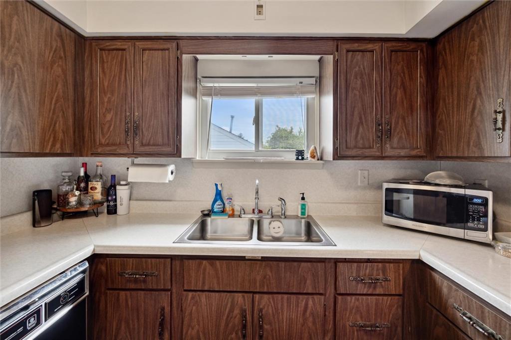 2433 Brodhead Road Aliquippa, PA 15001 - Photo 12 of 37 a kitchen with stainless steel appliances wooden cabinets and a sink