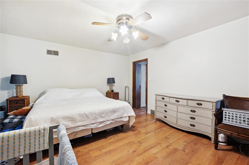 2433 Brodhead Road Aliquippa, PA 15001 - Photo 16 of 37 a spacious bedroom with a bed a chandelier and closet