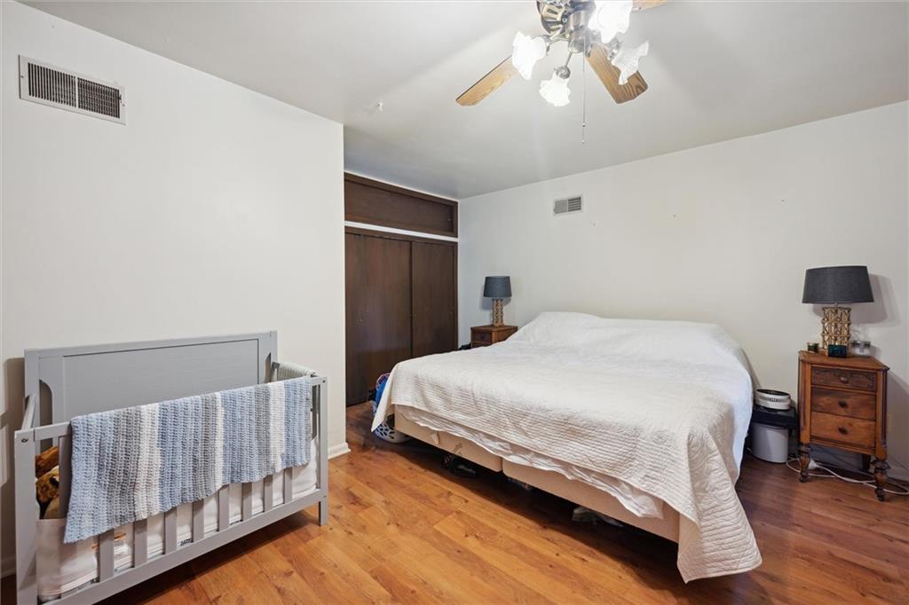 2433 Brodhead Road Aliquippa, PA 15001 - Photo 17 of 37 a bedroom with a bed and wooden floor