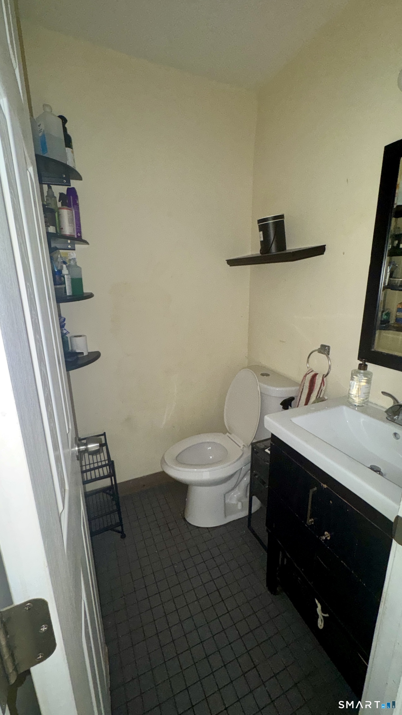 49 Ridge Road, Unit 2 Naugatuck, CT 06770 - Photo 7 of 7 a bathroom with a granite countertop toilet sink and mirror