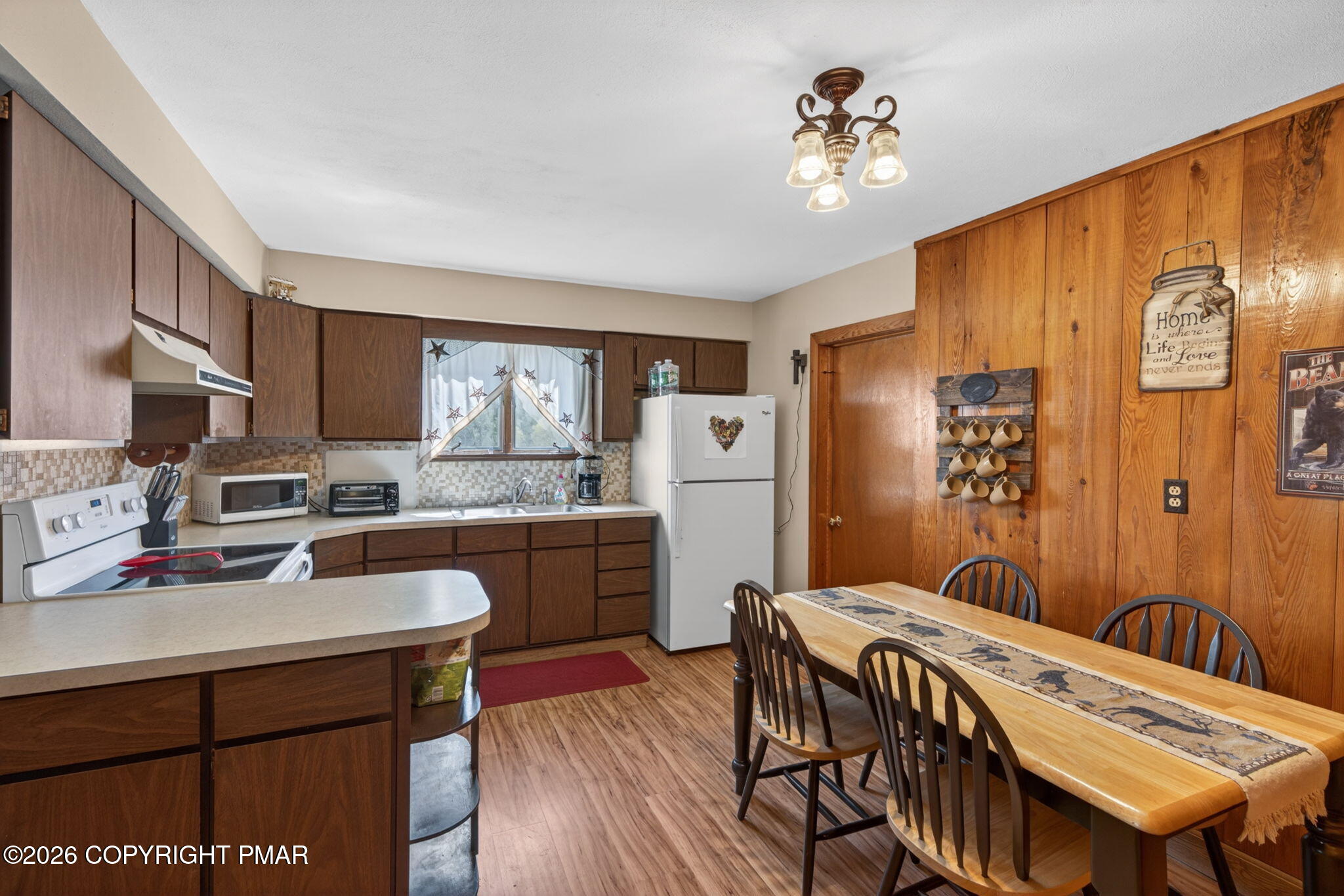 448 Criddle Road Susquehanna, PA 18847 - Photo 20 of 55 a kitchen with a table chairs refrigerator and cabinets
