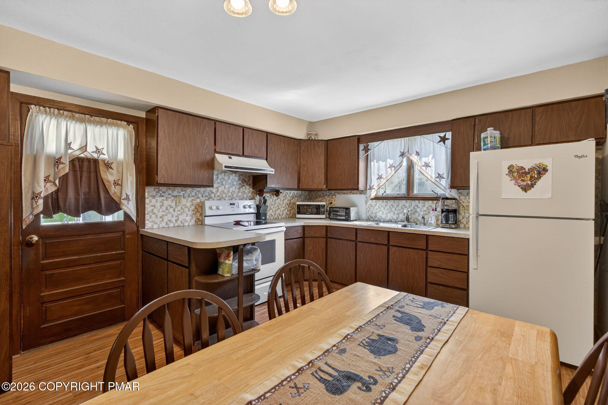 448 Criddle Road Susquehanna, PA 18847 - Photo 21 of 55 a kitchen with a refrigerator a stove a sink dishwasher and wooden cabinets with wooden floor