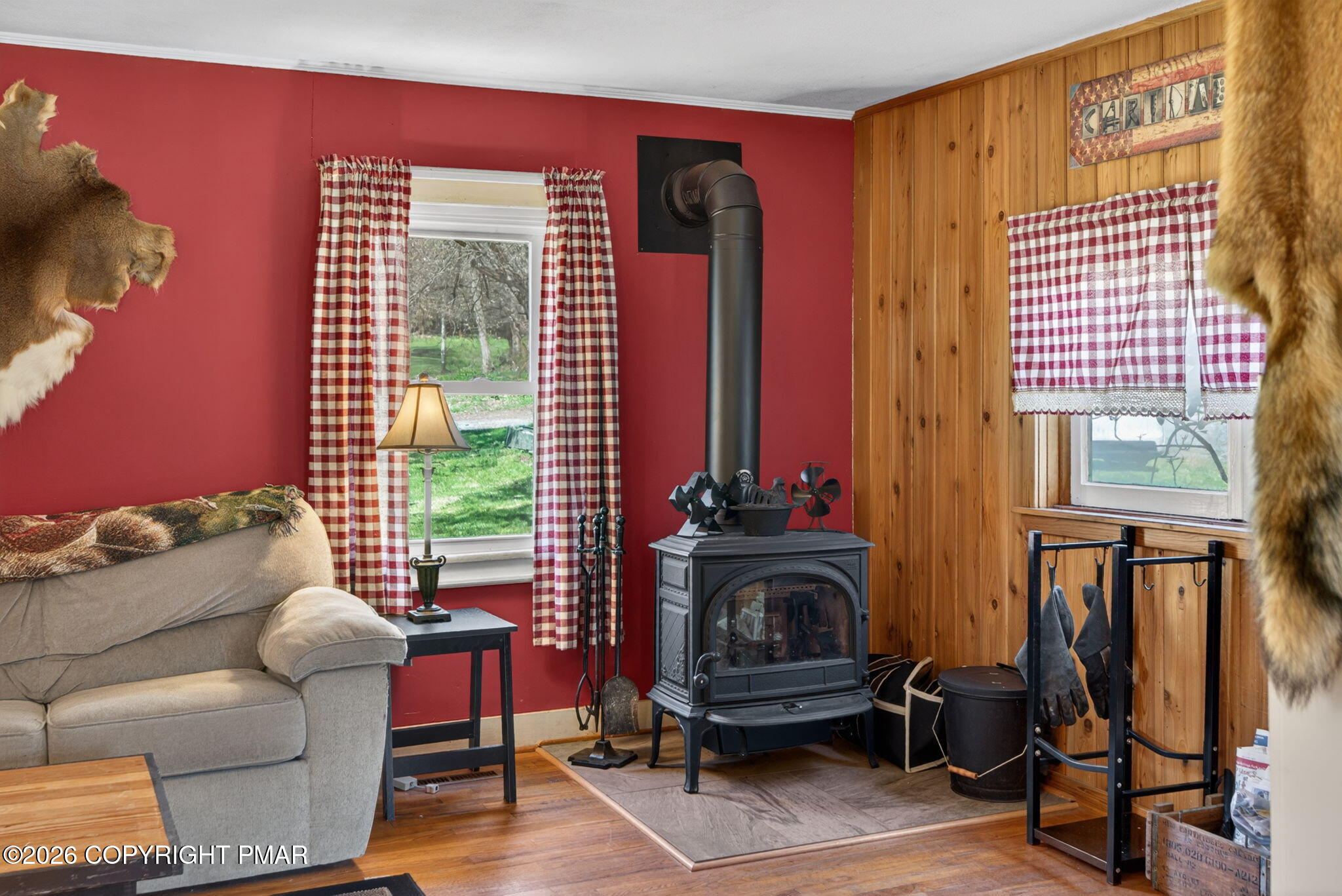 448 Criddle Road Susquehanna, PA 18847 - Photo 29 of 55 a living room with furniture a fireplace and a floor to ceiling window