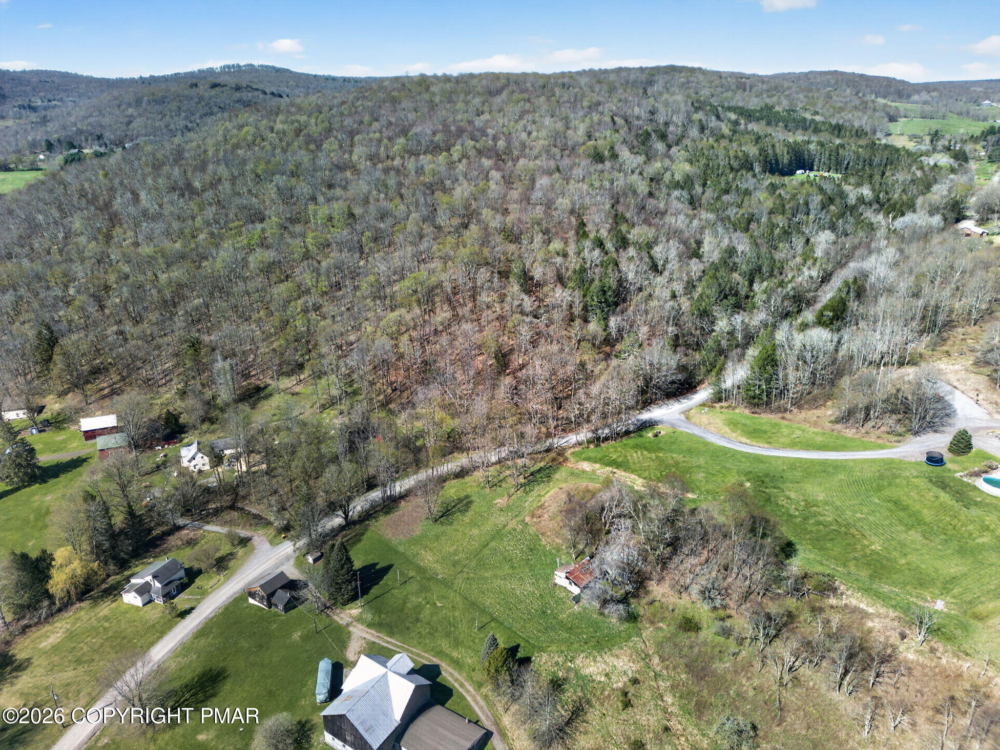 448 Criddle Road Susquehanna, PA 18847 - Photo 50 of 55 a view of a lush green hillside next to a building