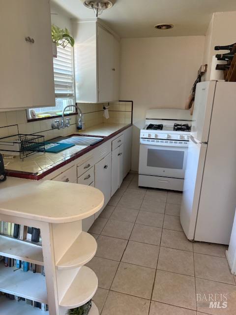 618 Benton Street Santa Rosa, CA 95404 - Photo 15 of 27 a kitchen with a stove a sink and a refrigerator