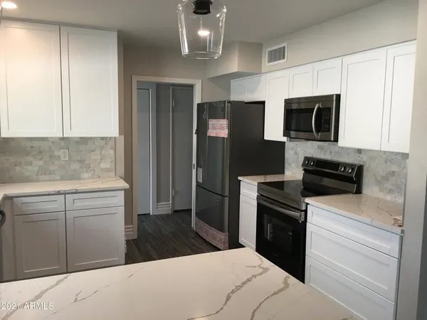 a kitchen with a refrigerator stove and microwave