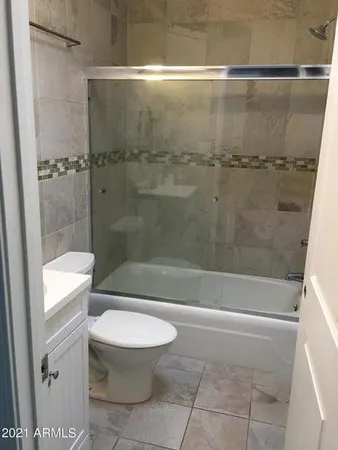 a bathroom with a shower and a toilet