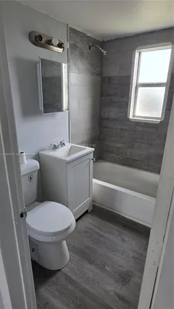 a bathroom with a toilet a sink and bathtub