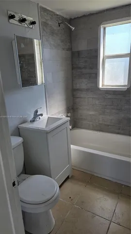 a bathroom with a sink toilet and bathtub