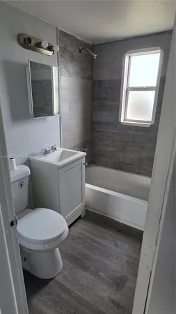 a bathroom with a toilet a sink and bathtub