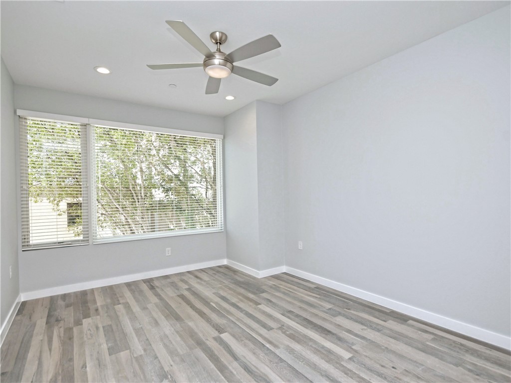 2108 Tillery Street, Unit 2102 Austin, TX 78723 - Photo 10 of 26 The primary bedroom has plentiful natural light courtesy of the large window.