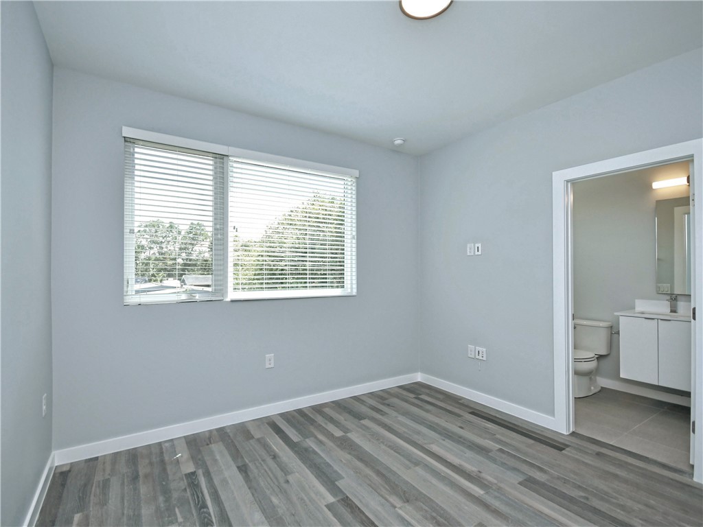 2108 Tillery Street, Unit 2102 Austin, TX 78723 - Photo 17 of 26 The second bedroom is a great size with solid oak wood flooring and plentiful natural light.