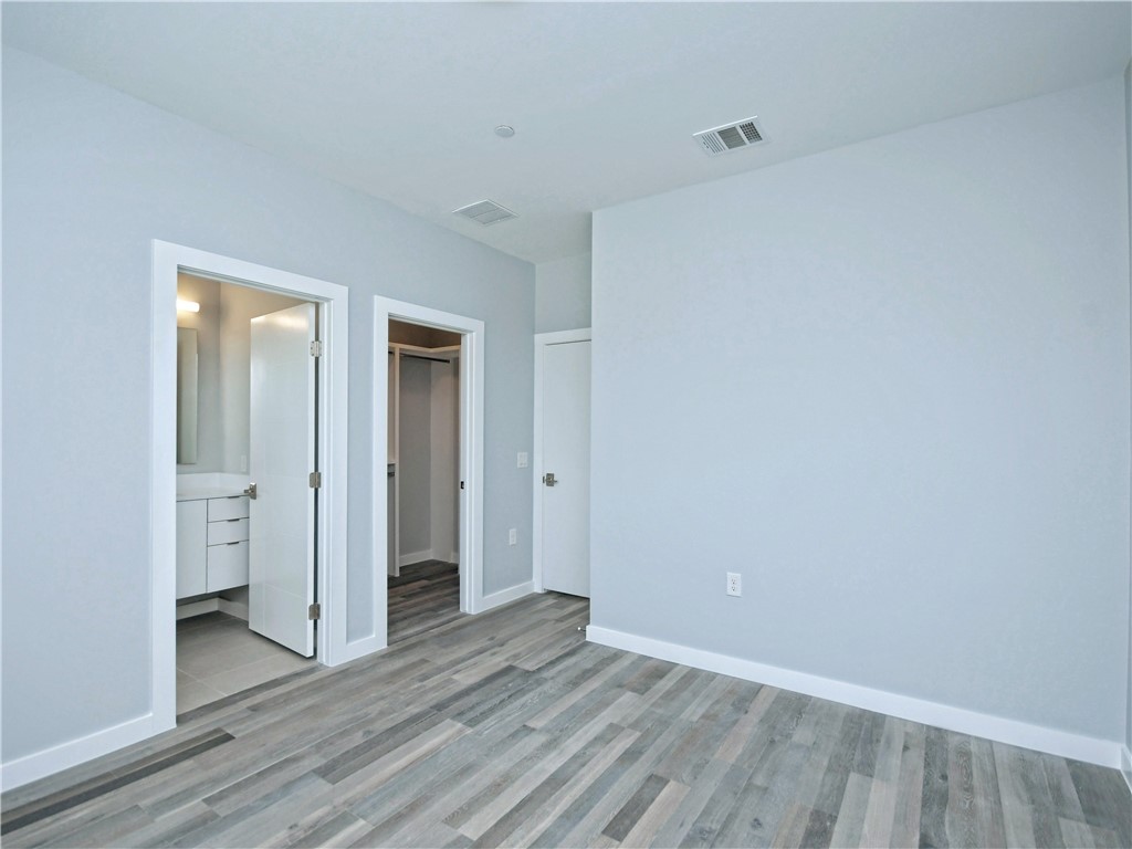 2108 Tillery Street, Unit 2102 Austin, TX 78723 - Photo 18 of 26 The second bedroom also has a walk-in closet and an en-suite.