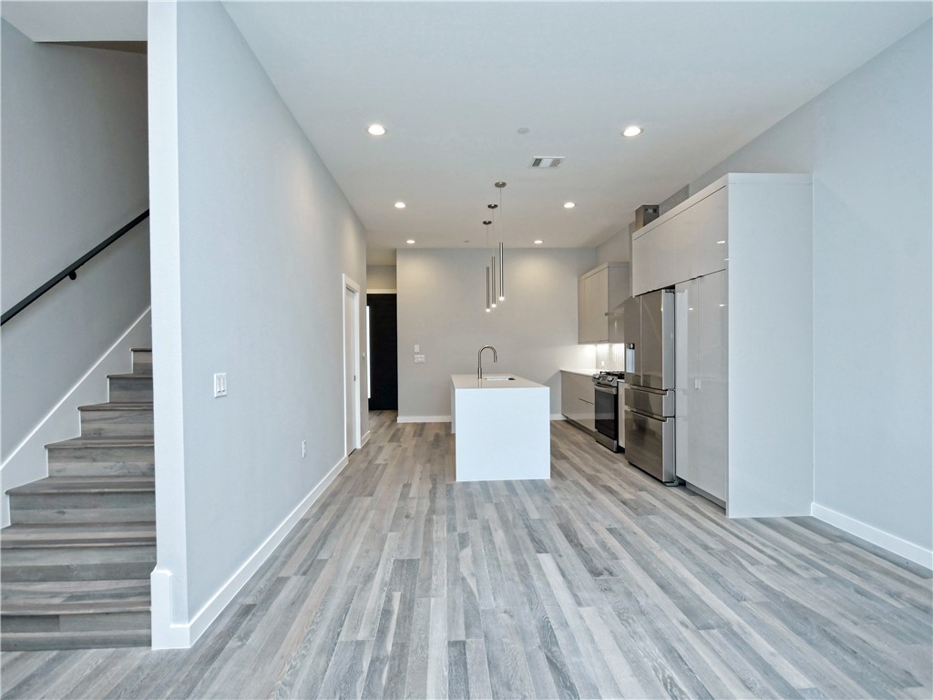 2108 Tillery Street, Unit 2102 Austin, TX 78723 - Photo 6 of 26 Notice the wood staircase and modern stair railing!