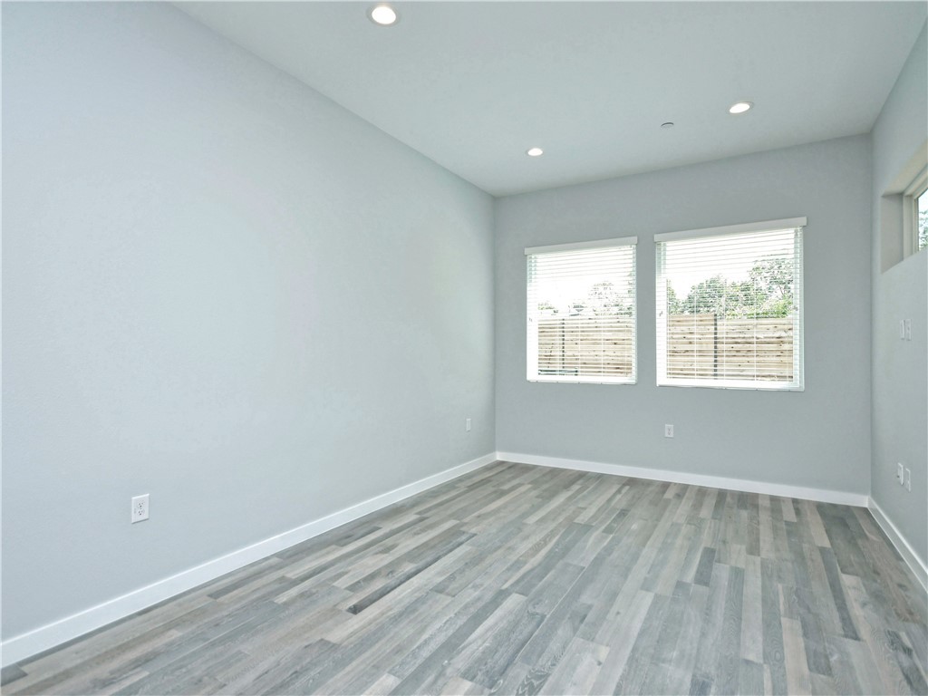 2108 Tillery Street, Unit 2102 Austin, TX 78723 - Photo 9 of 26 The living room is spacious and features gorgeous oak wood flooring and a neutral color palette.