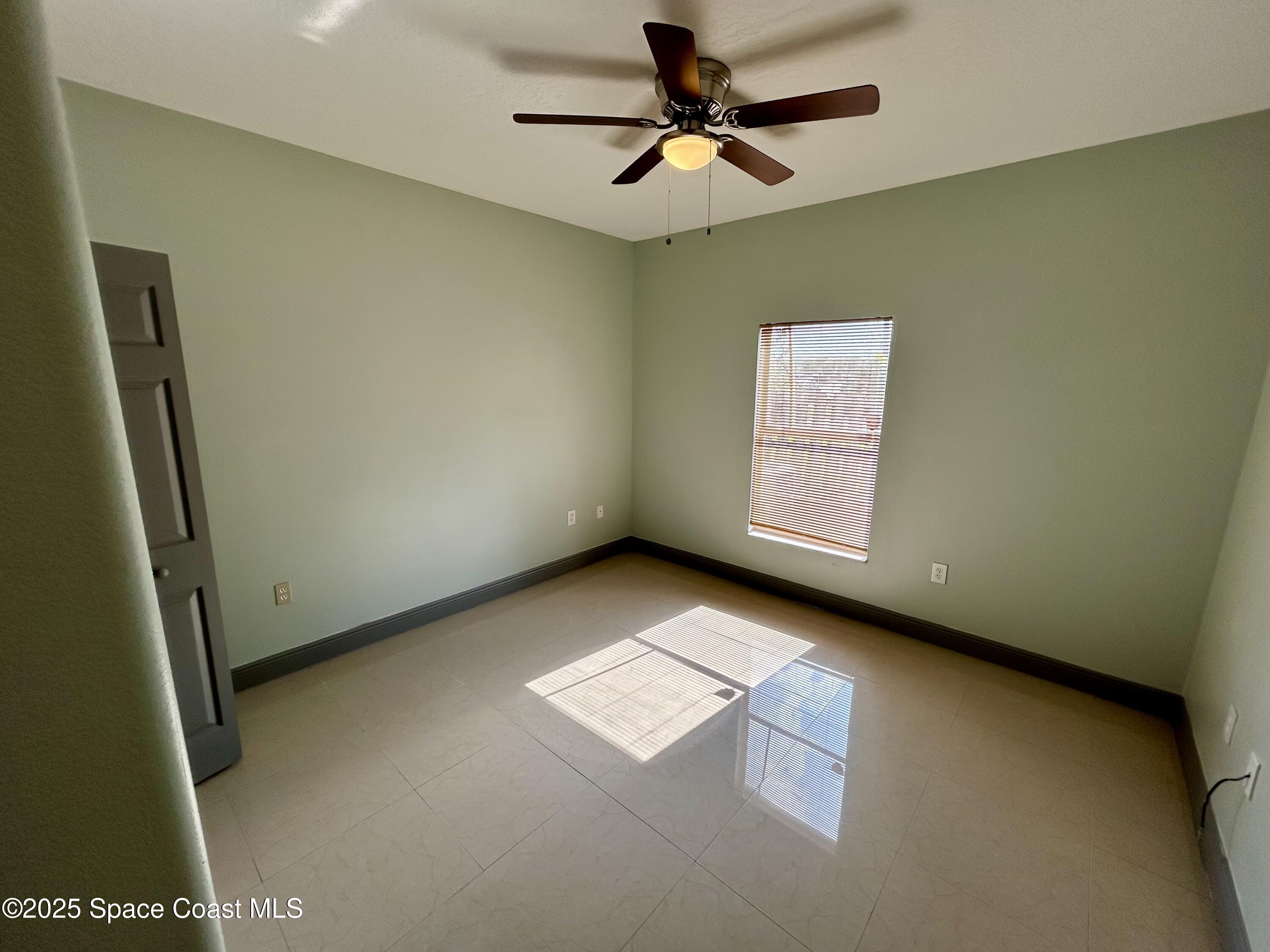 910 Twisting Branch Court Melbourne, FL 32935 - Photo 13 of 24 a view of an empty room and window