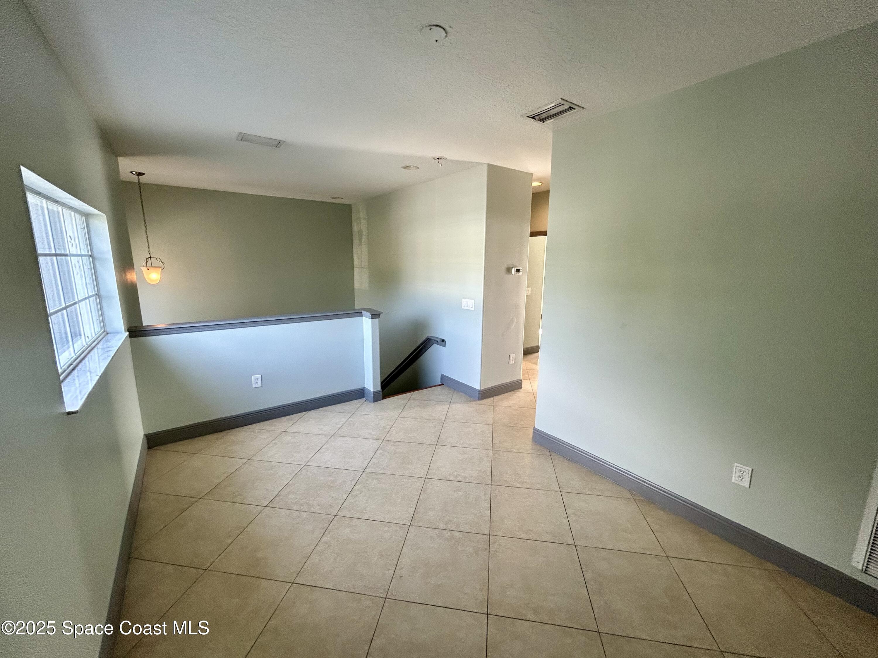 910 Twisting Branch Court Melbourne, FL 32935 - Photo 15 of 24 a view of an empty room and window